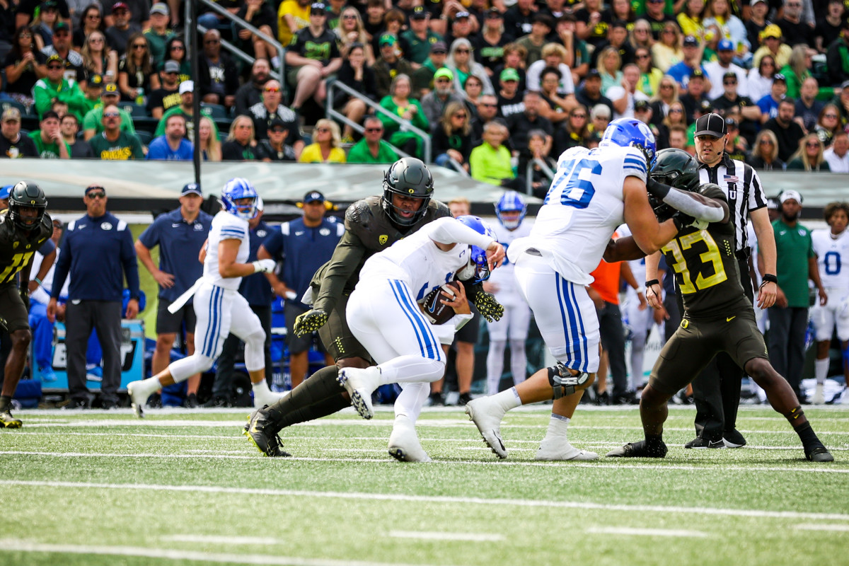 Oregon Ducks outside linebacker DJ Johnson tackles BYU quarterback Jaren Hall in week 3 at Autzen Stadium.